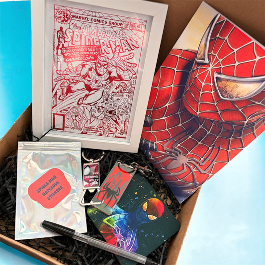 Hand-Made Spider-Man Gift Set - Exclusive 5x7 Foil Print, Notebook, and More!  Our Spider-Man Gift Set is a sensational collection celebrating everyone's favorite wall-crawler! Dive into the superhero universe with a framed 5x7 high-gloss foil print of The Amazing Spider-Man comic cover, accompanied by a range of themed accessories.