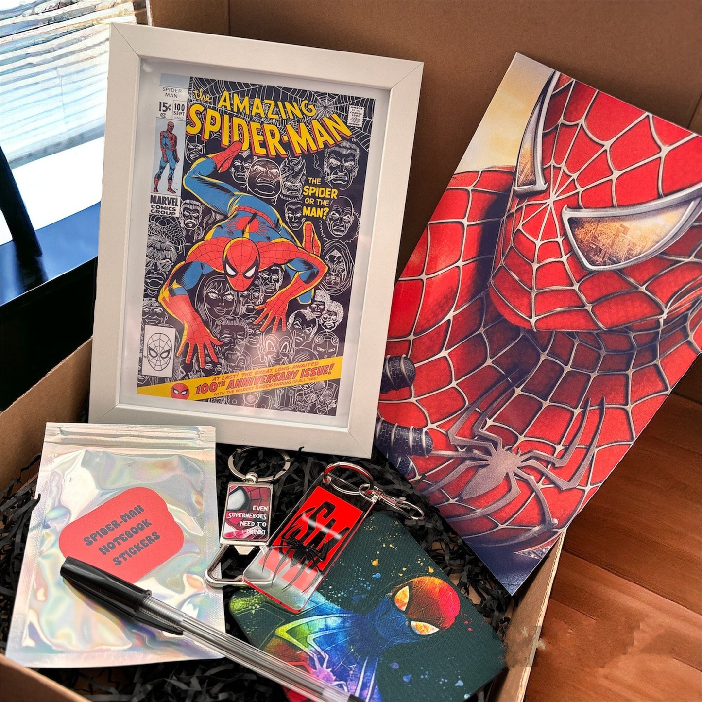 Hand-Made Spider-Man Gift Set - Exclusive 5x7 Foil Print, Notebook, and More!  Our Spider-Man Gift Set is a sensational collection celebrating everyone's favorite wall-crawler! Dive into the superhero universe with a framed 5x7 high-gloss foil print of The Amazing Spider-Man comic cover, accompanied by a range of themed accessories.