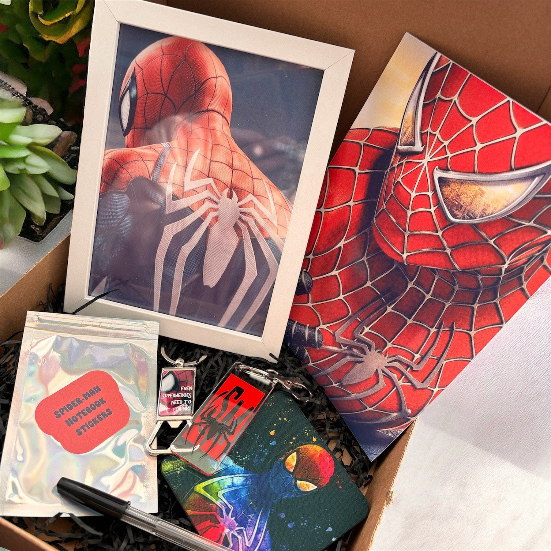 Hand-Made Spider-Man Gift Set - Exclusive 5x7 Foil Print, Notebook, and More!  Our Spider-Man Gift Set is a sensational collection celebrating everyone's favorite wall-crawler! Dive into the superhero universe with a framed 5x7 high-gloss foil print of The Amazing Spider-Man comic cover, accompanied by a range of themed accessories.