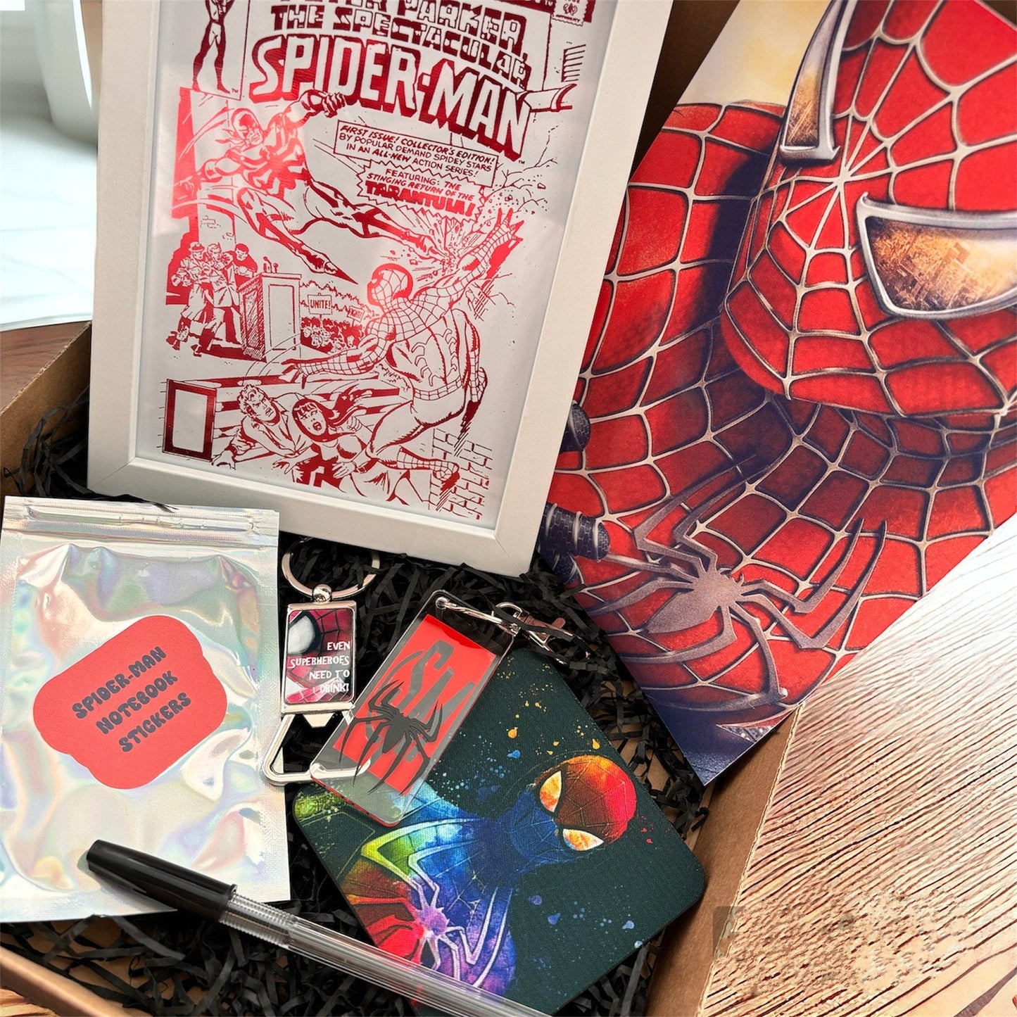 Hand-Made Spider-Man Gift Set - Exclusive 5x7 Foil Print, Notebook, and More!  Our Spider-Man Gift Set is a sensational collection celebrating everyone's favorite wall-crawler! Dive into the superhero universe with a framed 5x7 high-gloss foil print of The Amazing Spider-Man comic cover, accompanied by a range of themed accessories.