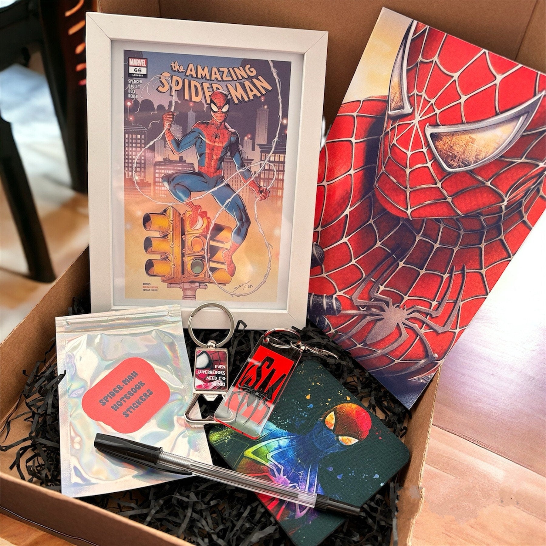 Hand-Made Spider-Man Gift Set - Exclusive 5x7 Foil Print, Notebook, and More!  Our Spider-Man Gift Set is a sensational collection celebrating everyone's favorite wall-crawler! Dive into the superhero universe with a framed 5x7 high-gloss foil print of The Amazing Spider-Man comic cover, accompanied by a range of themed accessories.