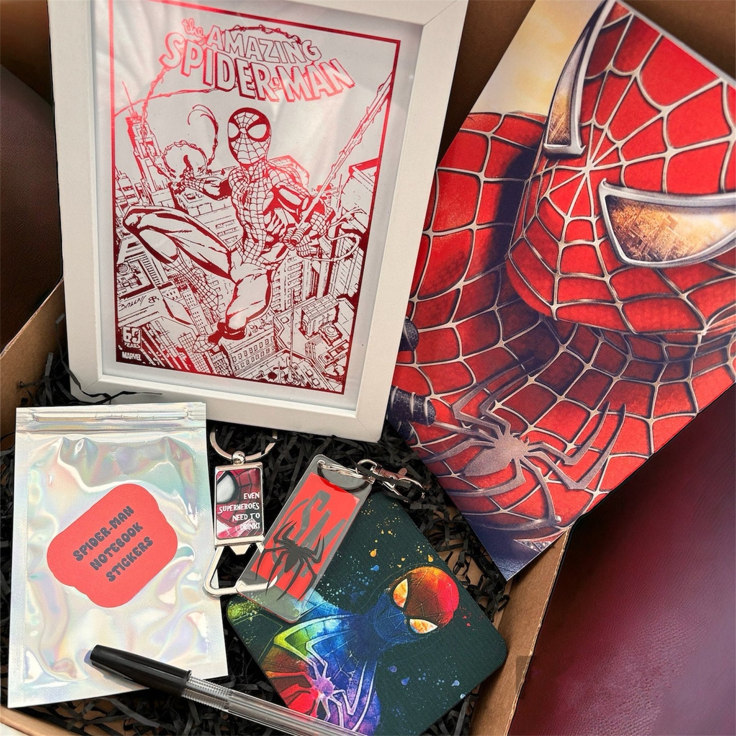 Hand-Made Spider-Man Gift Set - Exclusive 5x7 Foil Print, Notebook, and More!  Our Spider-Man Gift Set is a sensational collection celebrating everyone's favorite wall-crawler! Dive into the superhero universe with a framed 5x7 high-gloss foil print of The Amazing Spider-Man comic cover, accompanied by a range of themed accessories.